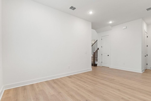 spare room with light hardwood / wood-style flooring