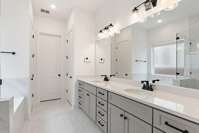 bathroom featuring vanity and shower with separate bathtub