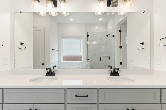 bathroom with vanity and a shower with shower door