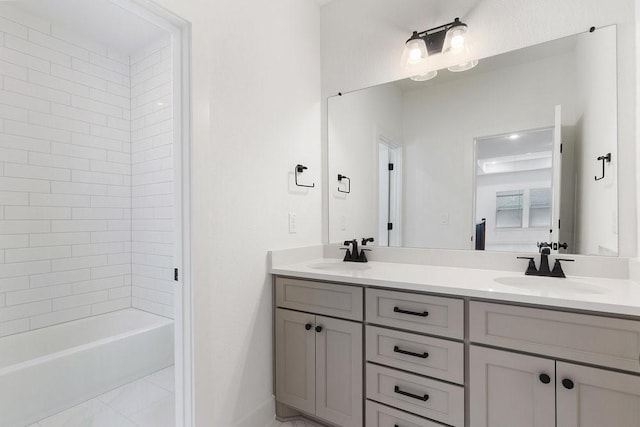 bathroom with vanity and tiled shower / bath combo