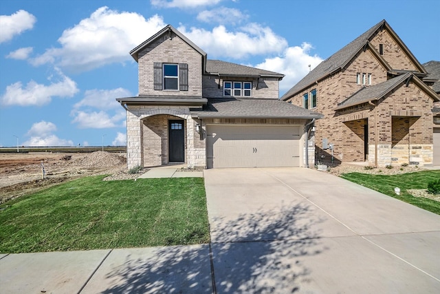 view of front of house with a garage and a front lawn