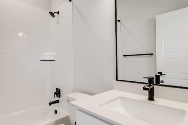 full bathroom with vanity, toilet, and tiled shower / bath combo