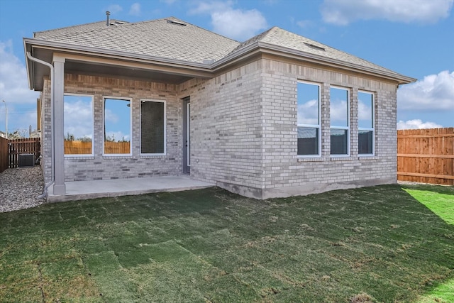 rear view of property with a patio area, a lawn, and cooling unit