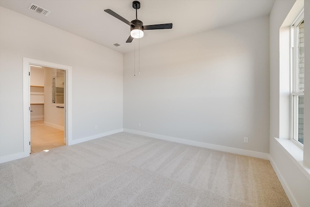 carpeted empty room featuring ceiling fan