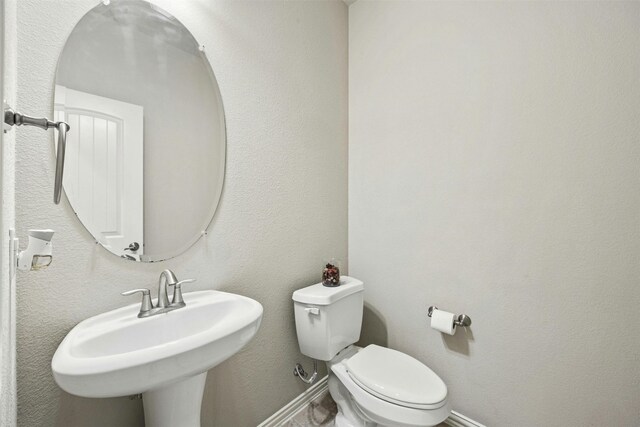 bathroom with toilet and sink