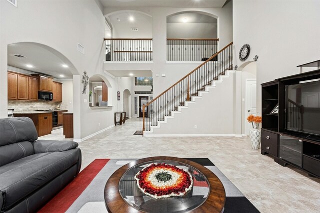 tiled living room featuring a high ceiling