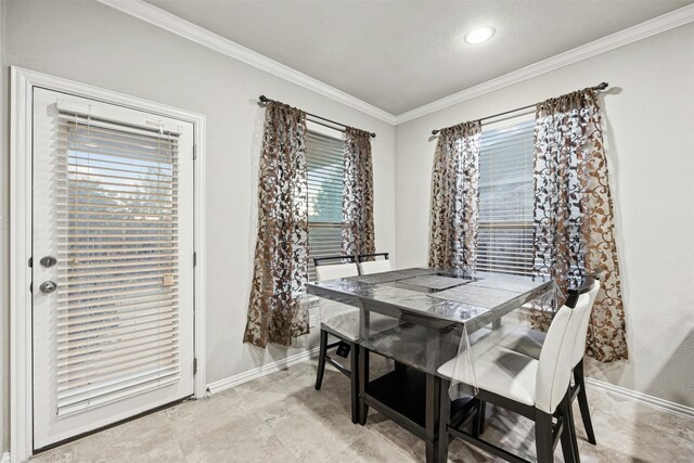 dining space featuring ornamental molding and a textured ceiling