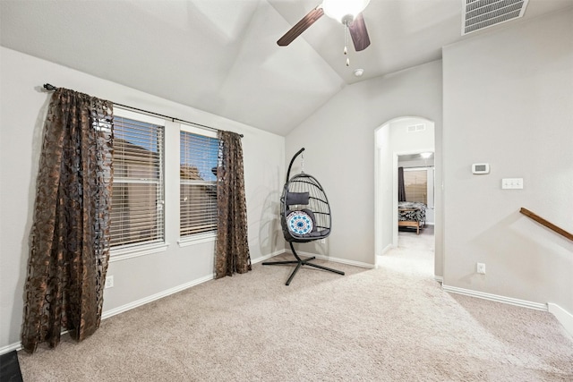 interior space featuring ceiling fan, carpet flooring, and lofted ceiling