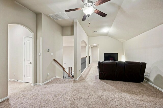 carpeted living room featuring ceiling fan and vaulted ceiling