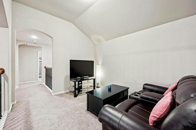 living room featuring light carpet and vaulted ceiling