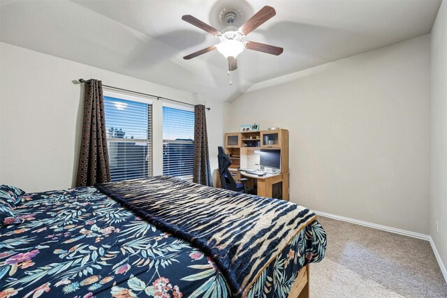 carpeted bedroom with ceiling fan and vaulted ceiling