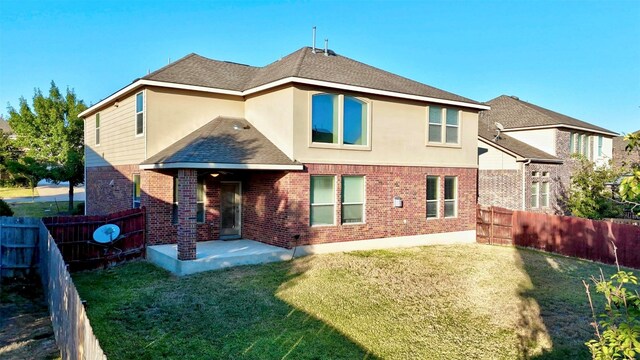 back of house with a patio and a yard