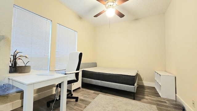 bedroom featuring ceiling fan, a textured ceiling, and light hardwood / wood-style flooring