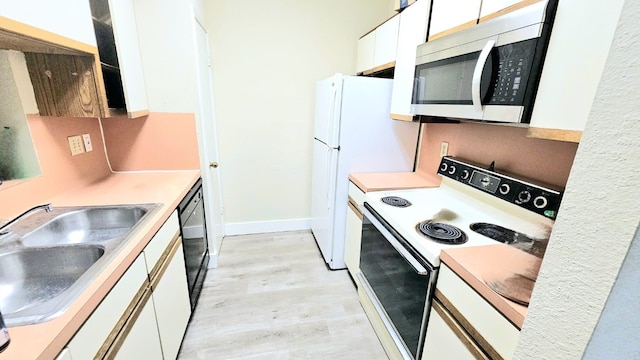 kitchen with black dishwasher, sink, light wood-type flooring, electric stove, and white cabinets