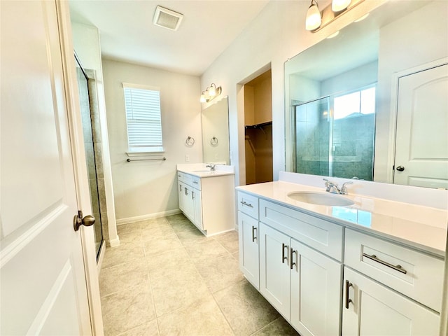 bathroom with vanity, walk in shower, and tile patterned flooring