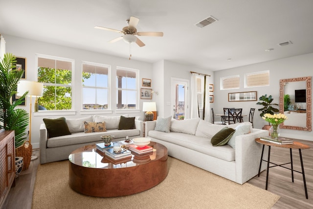 living room with ceiling fan and hardwood / wood-style flooring