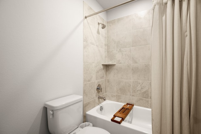 bathroom featuring shower / bath combo with shower curtain and toilet