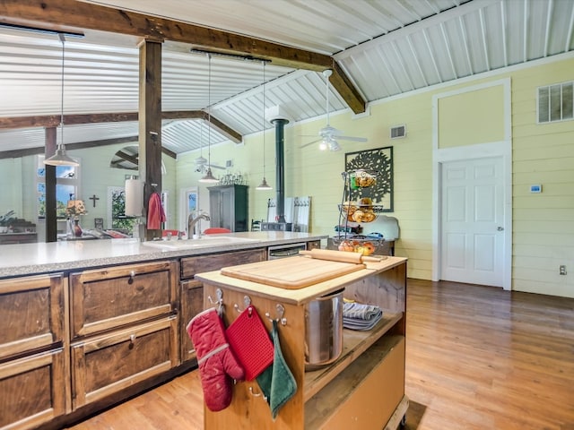 bathroom with vaulted ceiling with beams, sink, wood-type flooring, and ceiling fan