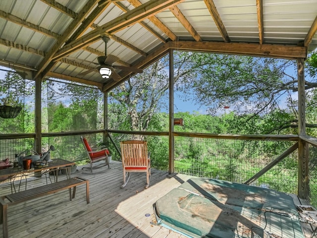 unfurnished sunroom with lofted ceiling with beams and ceiling fan