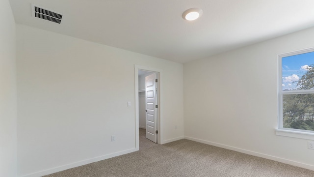 carpeted empty room with a healthy amount of sunlight