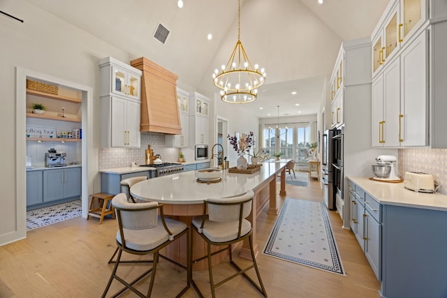 kitchen with white cabinetry, a spacious island, pendant lighting, and custom exhaust hood