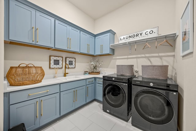 laundry area featuring sink, washer and dryer, light tile patterned floors, and cabinets