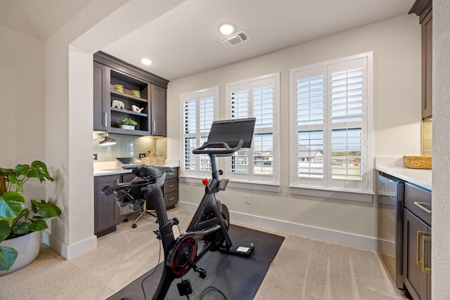 exercise area with light carpet and wine cooler