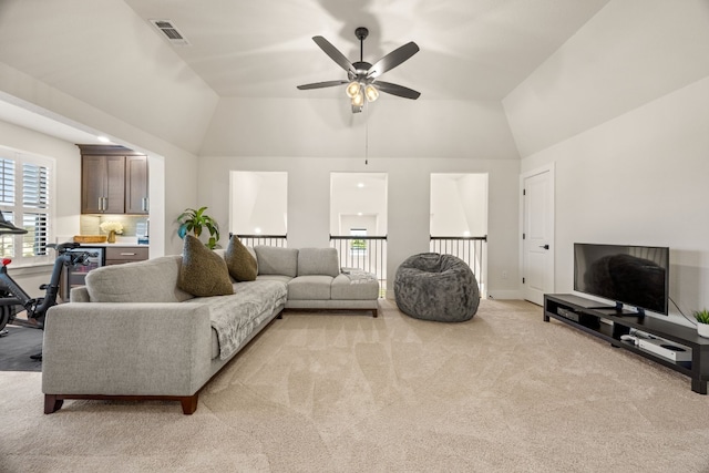 carpeted living room featuring lofted ceiling and ceiling fan