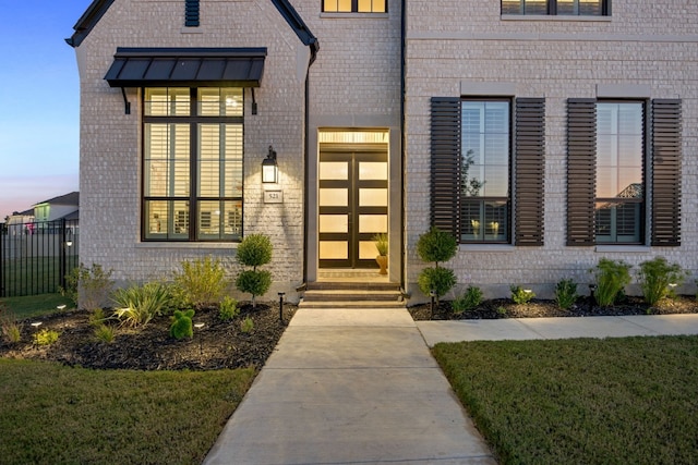 exterior entry at dusk with a yard