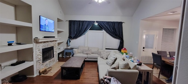 living room featuring a fireplace, hardwood / wood-style floors, vaulted ceiling, and ceiling fan