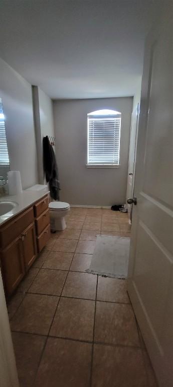 bathroom with tile patterned flooring, vanity, and toilet