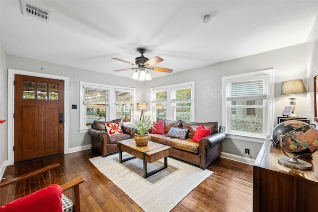 living room featuring a ceiling fan, baseboards, visible vents, and hardwood / wood-style floors