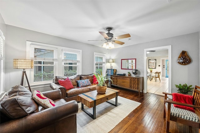 living room with dark wood-type flooring and ceiling fan