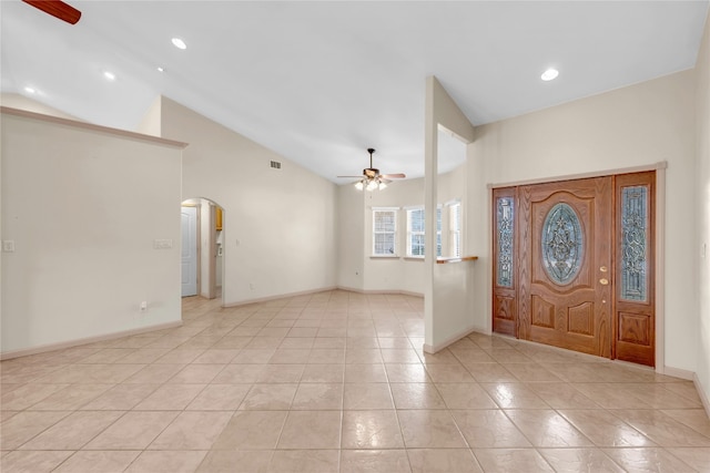 entryway featuring light tile patterned flooring, high vaulted ceiling, and ceiling fan