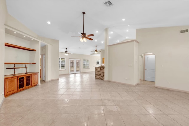 unfurnished living room featuring ceiling fan, high vaulted ceiling, and light tile patterned floors