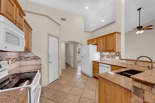 kitchen featuring white appliances, sink, ceiling fan, high vaulted ceiling, and light tile patterned floors