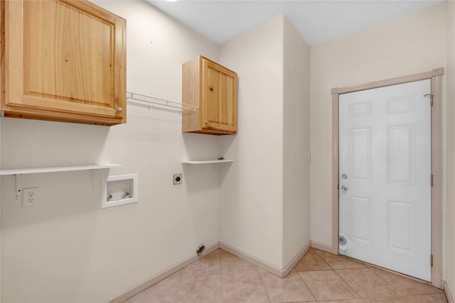 laundry area featuring cabinets, hookup for a washing machine, light tile patterned floors, and electric dryer hookup