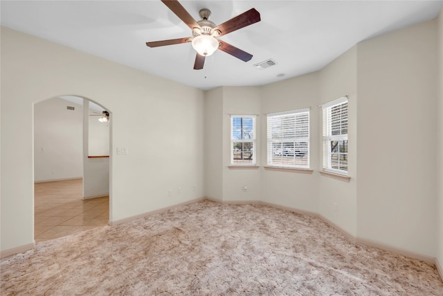 carpeted spare room featuring ceiling fan