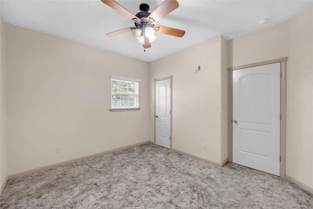 unfurnished bedroom with ceiling fan and light colored carpet