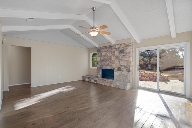 unfurnished living room with ceiling fan, a wealth of natural light, a fireplace, and dark hardwood / wood-style flooring