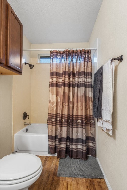 bathroom with toilet, shower / tub combo with curtain, and hardwood / wood-style flooring