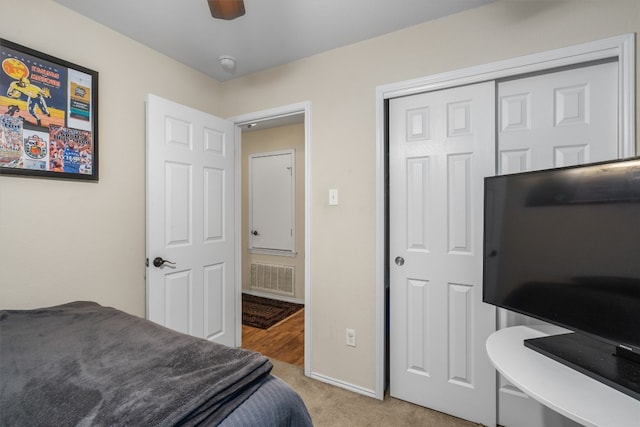 carpeted bedroom with a closet and ceiling fan