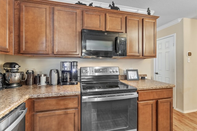 kitchen with light hardwood / wood-style floors, crown molding, stainless steel appliances, and light stone counters