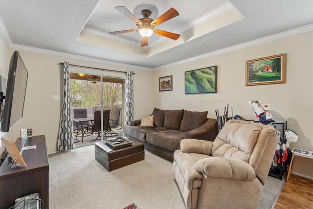 living room featuring crown molding, light wood-type flooring, and ceiling fan