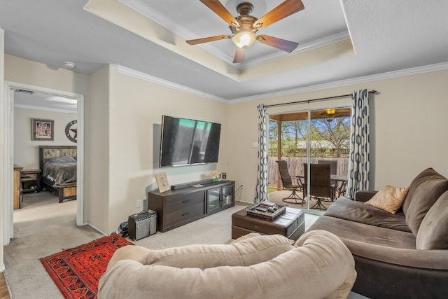 living room with ornamental molding, light colored carpet, and ceiling fan