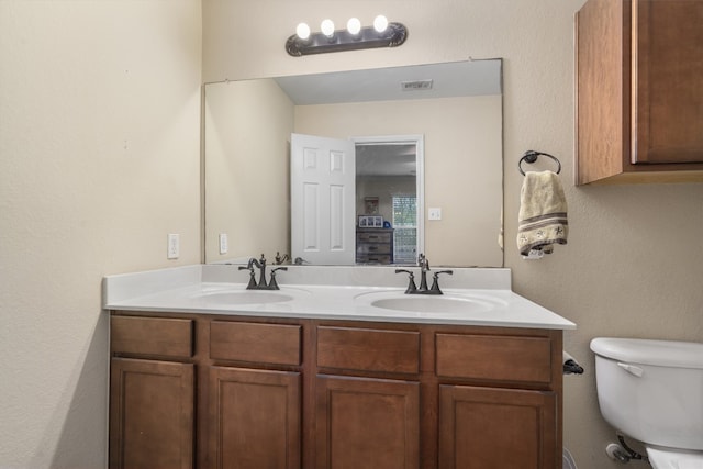 bathroom with toilet and vanity