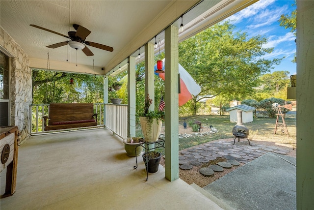 view of patio featuring a storage unit and ceiling fan