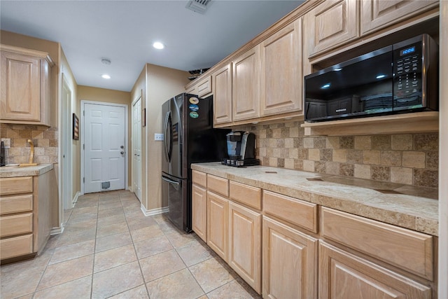 kitchen featuring light brown cabinets, light tile patterned floors, and backsplash