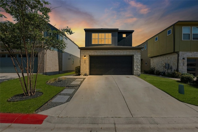 view of front facade with a garage and a lawn