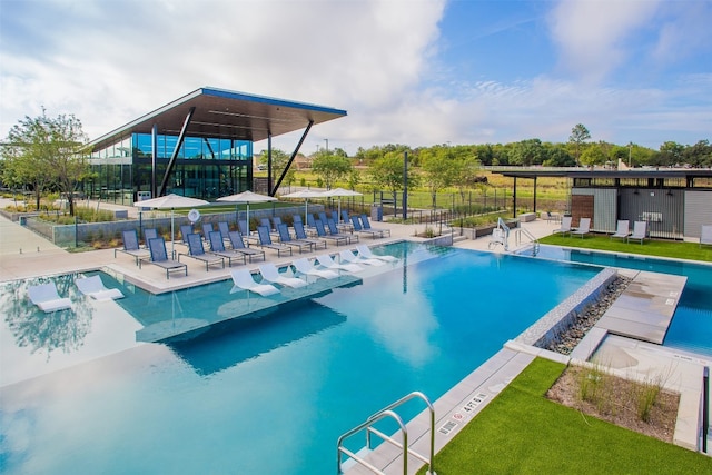 view of swimming pool with a patio and a yard